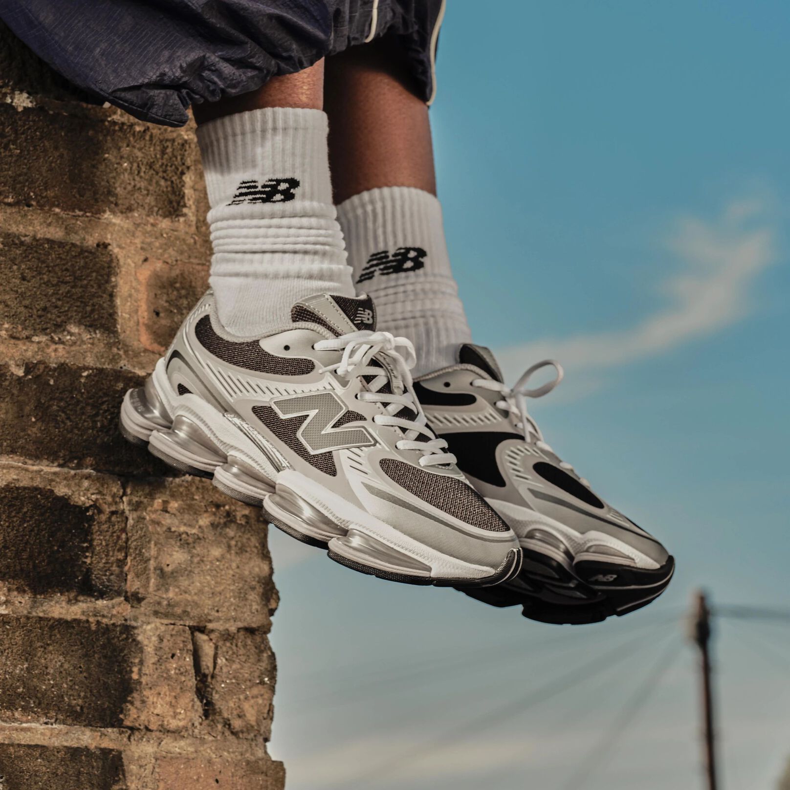 A woman standing against a barn backdrop. 